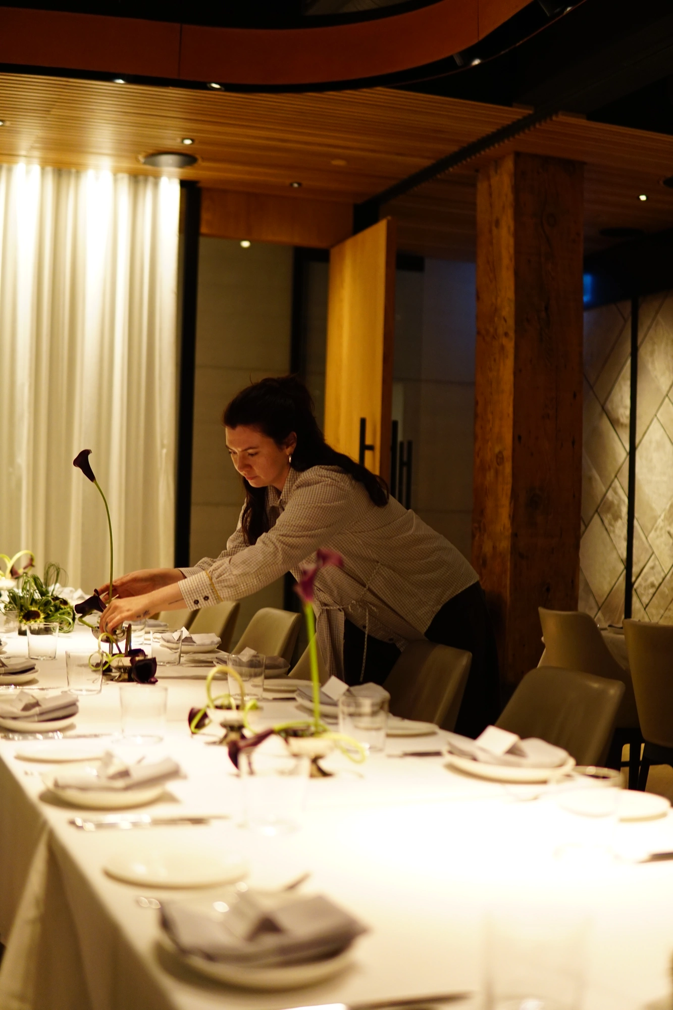 Long wedding table dressed with calla lily centrepieces before guests arrive