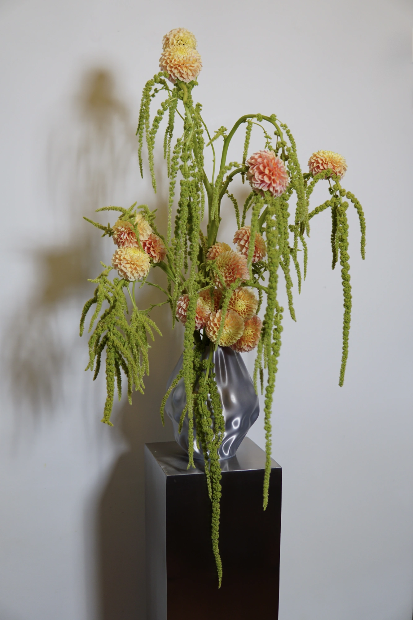 Peach dahlias and trailing amaranthus in a silver 3D-printed vase