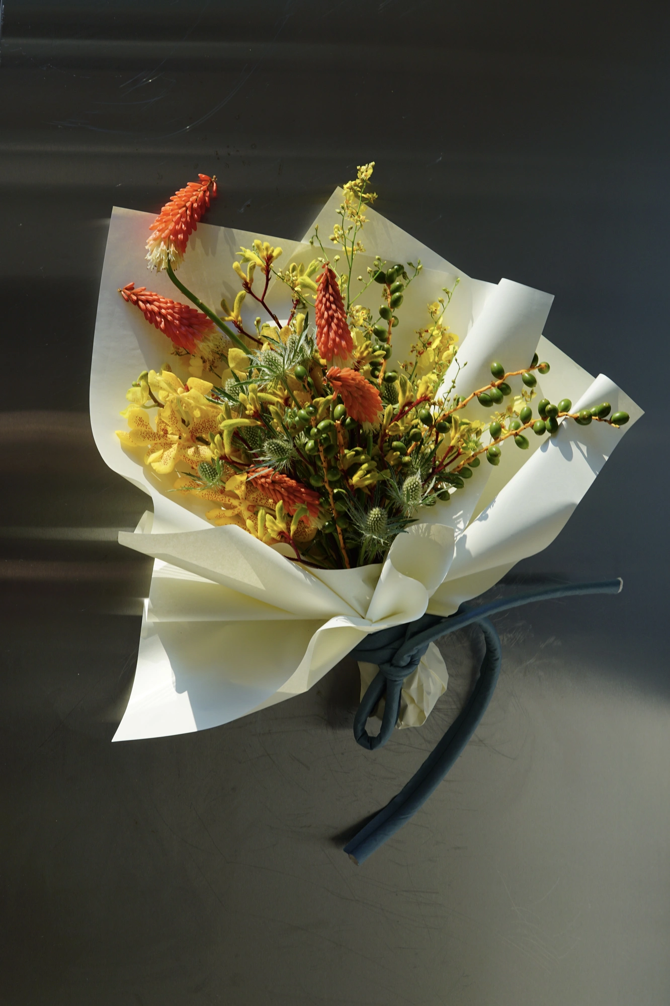 Dark calla and red orchid bouquet